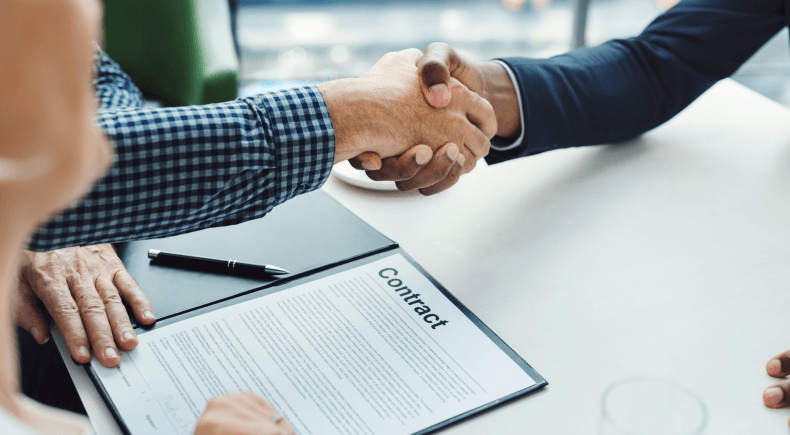 Close-up of two hands shaking in agreement over a business deal