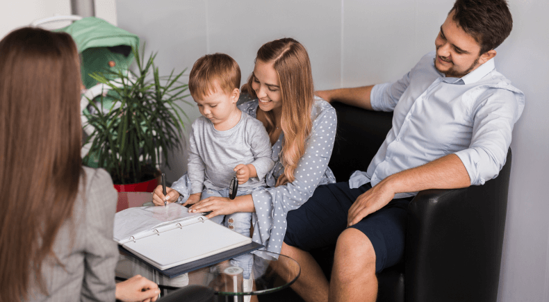 Family sitting in office lobby waiting to meet with loan agent