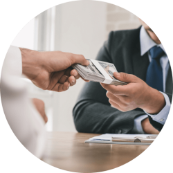 Two hands exchanging a bundle of dollar bills representing international commercial loans. Two hands exchanging a bundle of dollar bills representing international commercial loans.